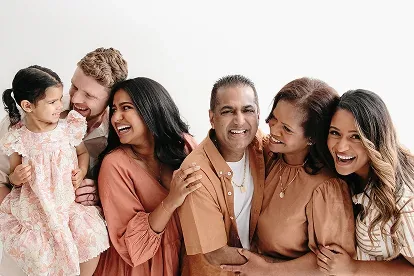 Three generations of a family laughing together in studio