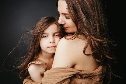 A mother holding her daughter close during a Verve portrait session