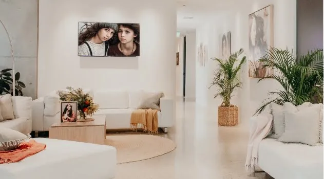 Inside the Verve Alexandria studio: white sofas and framed portraits along a light-filled hallway