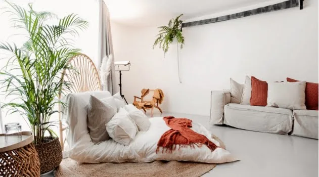 Inside the Verve Richmond studio: a styled bedroom set with plants and natural light